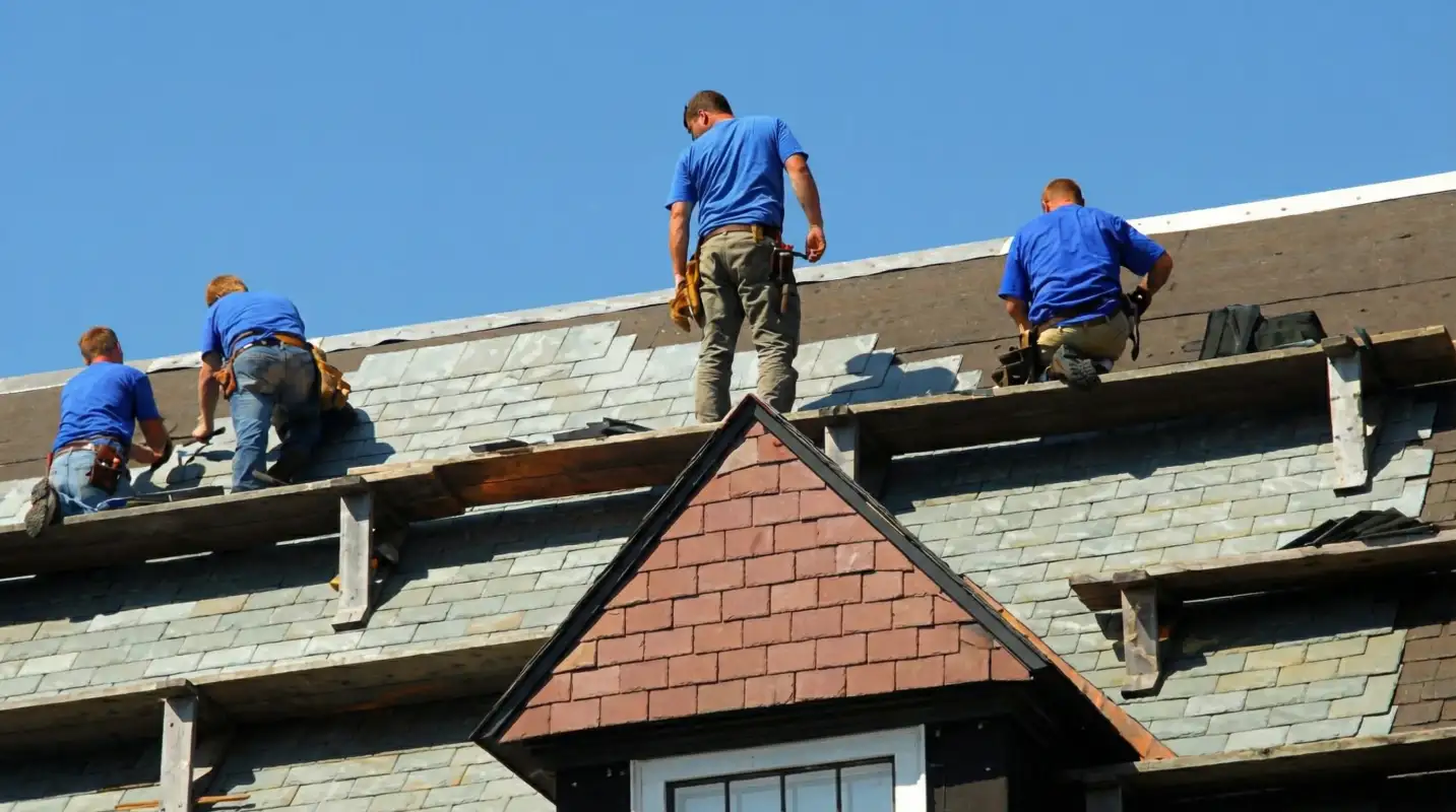 Roof replacement in progress with a team of professional contractors installing new shingles on a residential home in New Orleans, LA